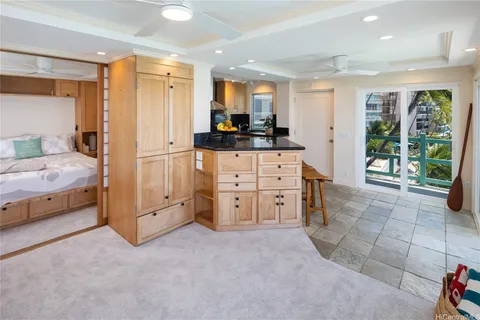 a large kitchen with cabinets and a large window