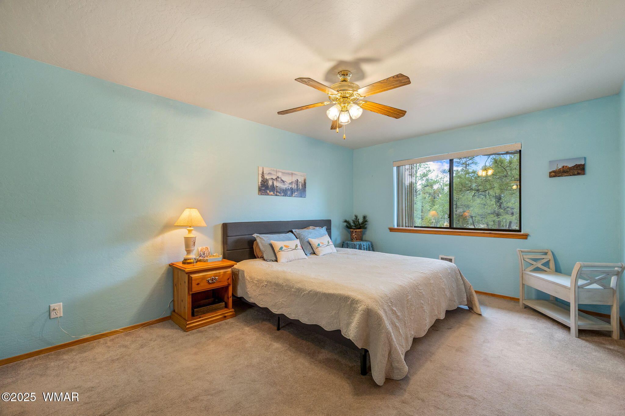 2088 Round-Up Road Overgaard, AZ 85933 - Photo 9 of 35 a bedroom with a bed and a chandelier