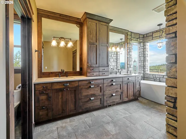 a bathroom with a granite countertop sink mirror and a bathtub