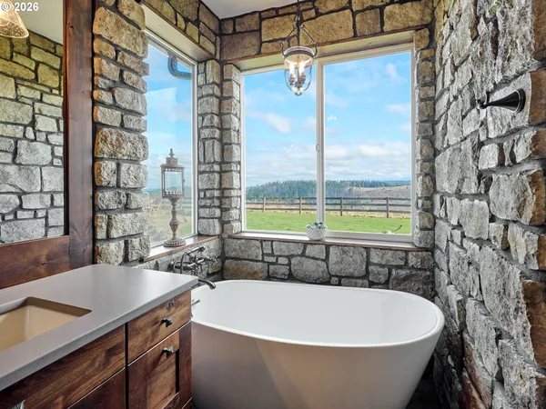 a white bath tub sitting next to a blue sink