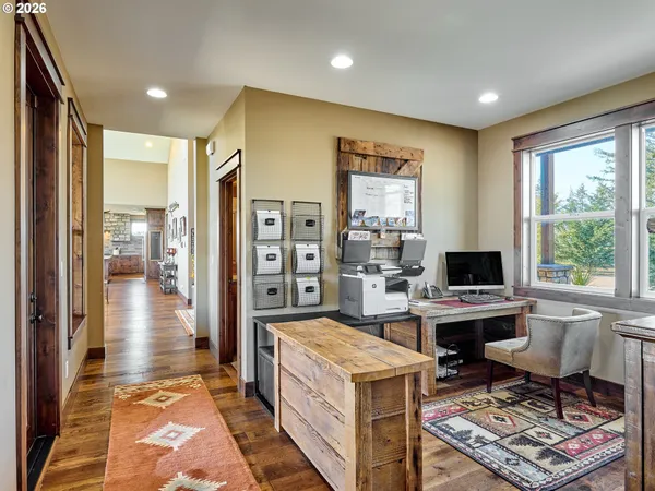 a view of a livingroom with workspace and a window