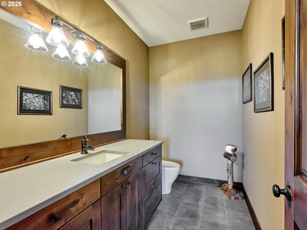 a bathroom with a double vanity sink mirror and toilet
