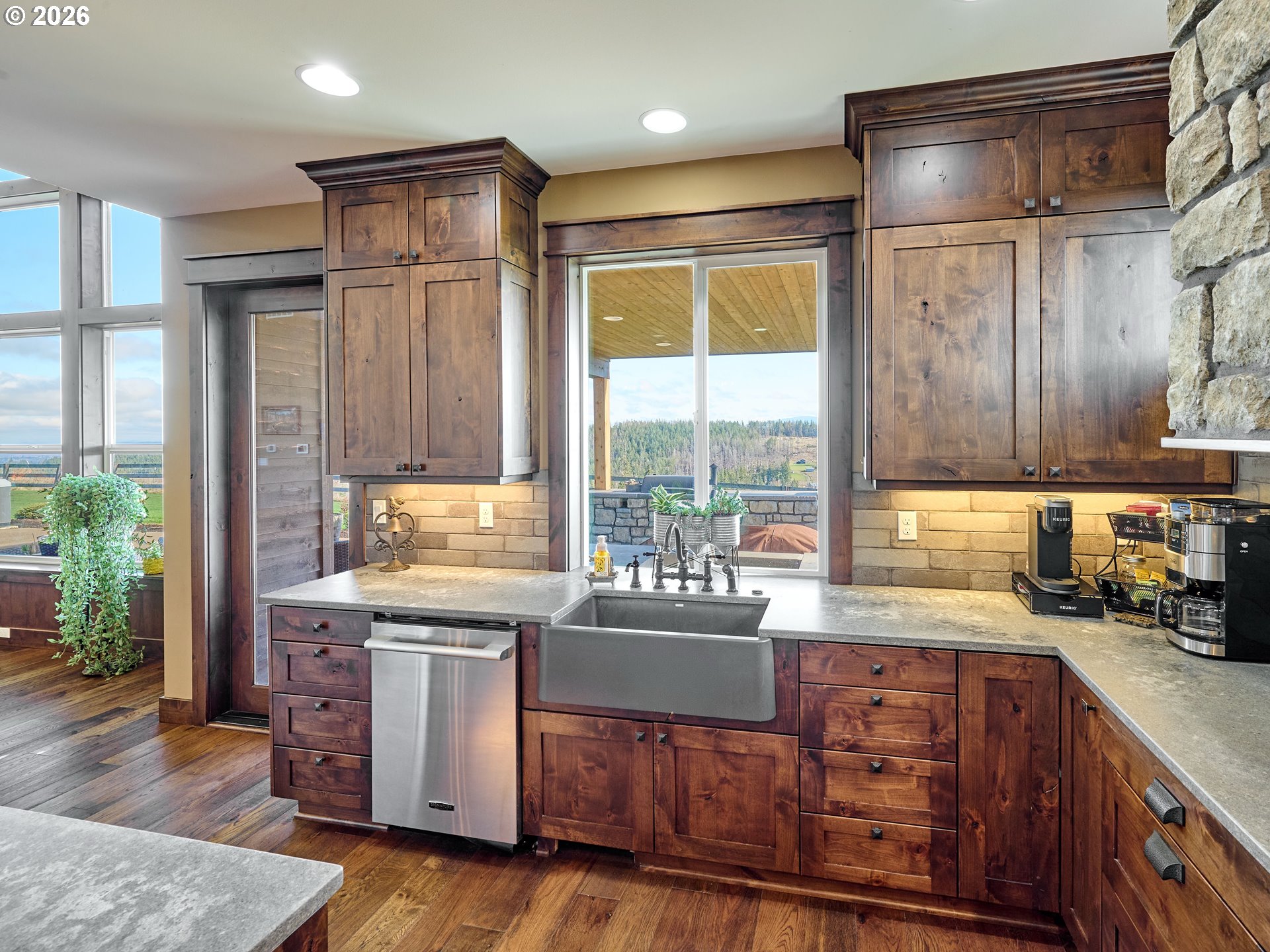 38252 South Blair Road Molalla, OR 97038 - Photo 7 of 47 a kitchen with kitchen island a stove a sink and wooden cabinets