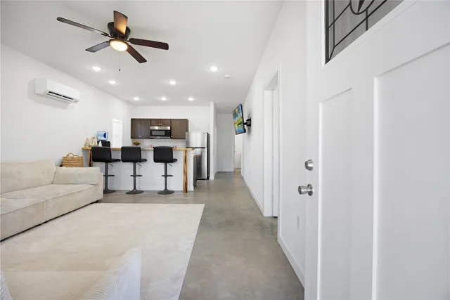 a living room with furniture and kitchen view
