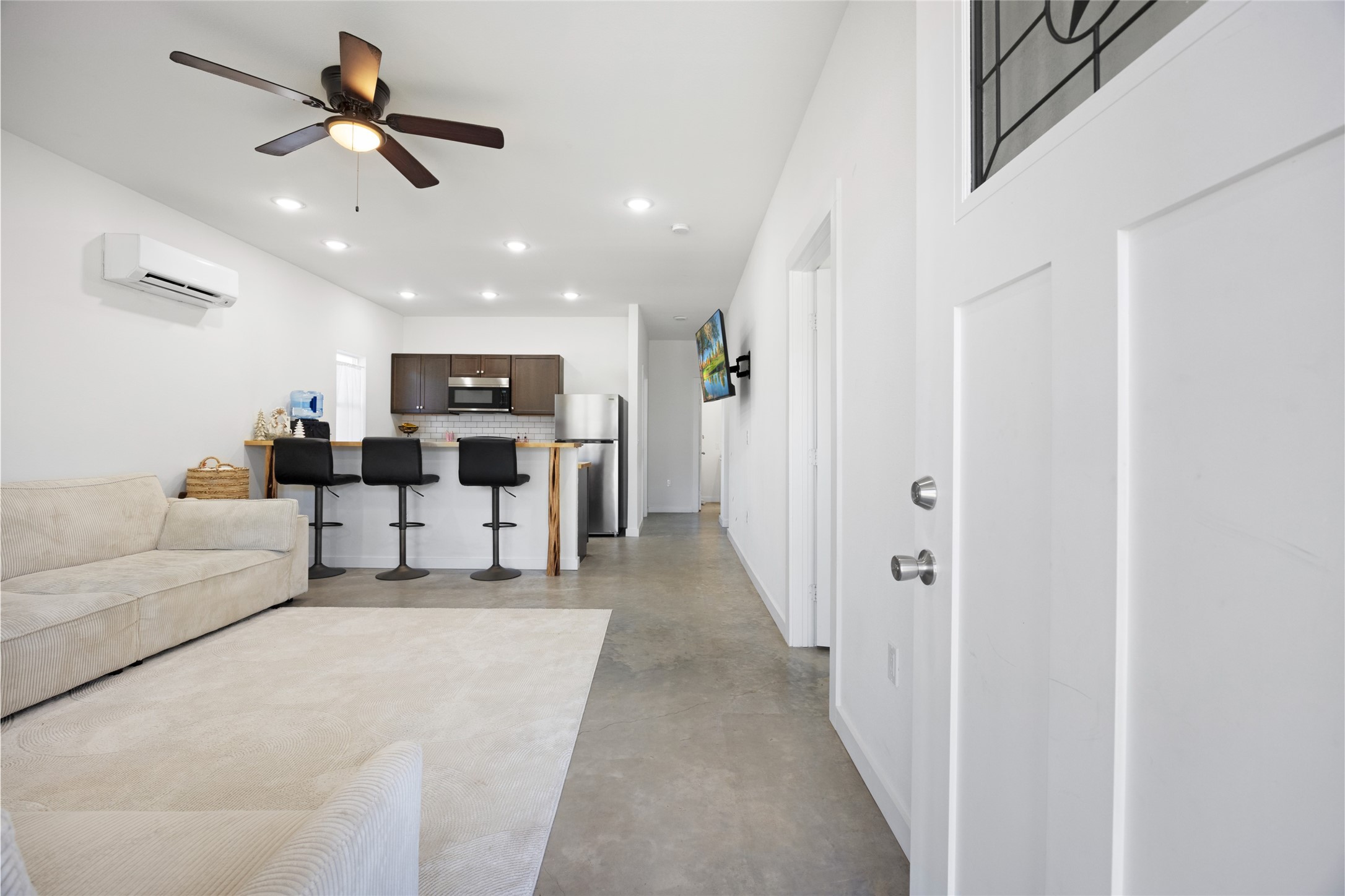 a living room with furniture and kitchen view