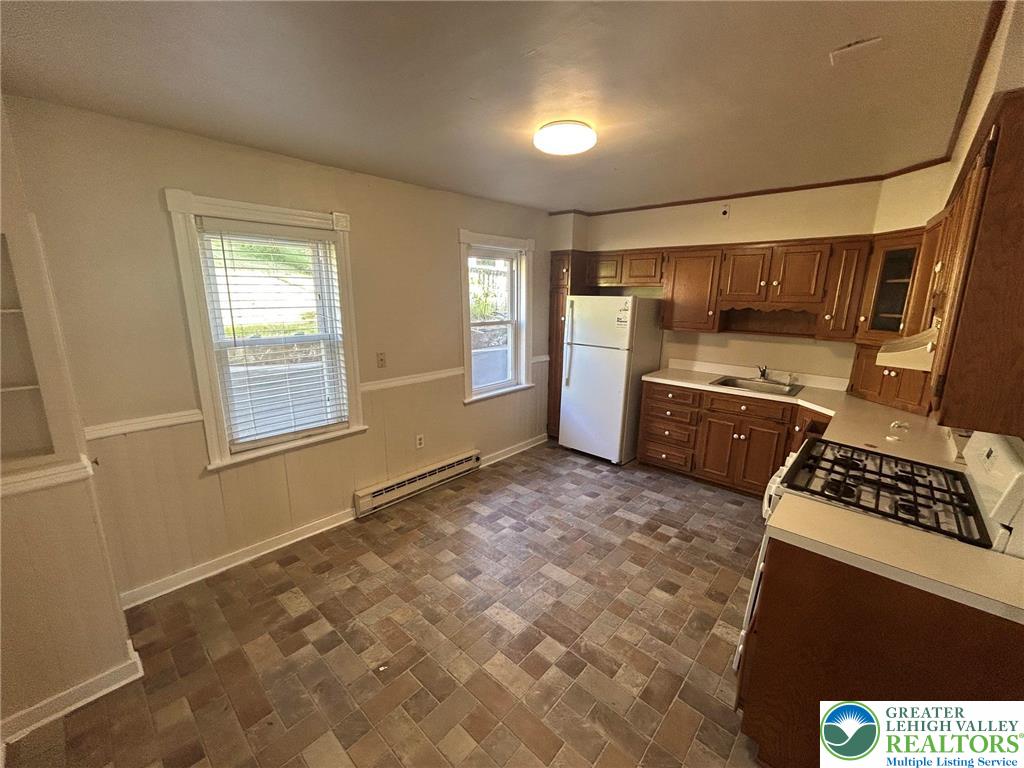 1122 East 4th Street Bethlehem, PA 18015 - Photo 6 of 13 Functional kitchen with ample cabinetry and easy-to-maintain tile flooring.