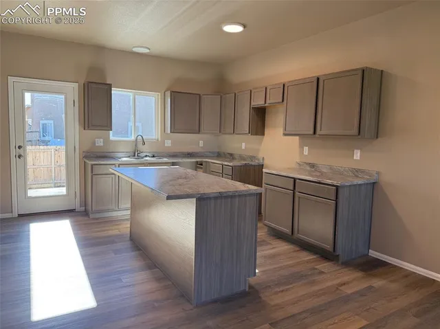 a kitchen with a sink stove and cabinets