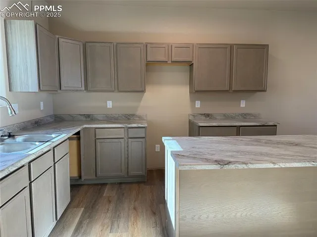 a kitchen with a sink a stove and cabinets