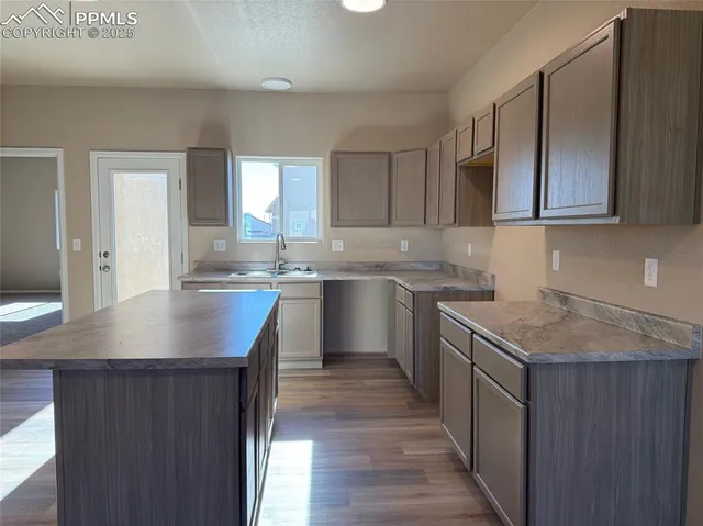 a kitchen with stainless steel appliances granite countertop a sink stove and cabinets