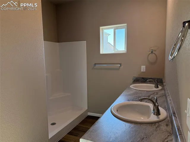a bathroom with a granite countertop toilet and a sink