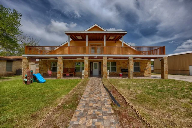 a view of a house with a garden and pathway