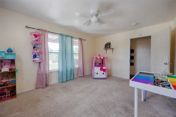 a bedroom with furniture a flat screen tv and a closet