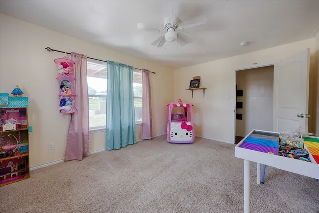 a bedroom with furniture a flat screen tv and a closet