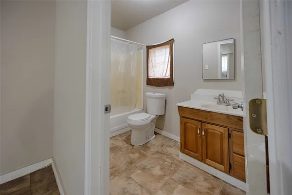 a spacious bathroom with a toilet sink and mirror