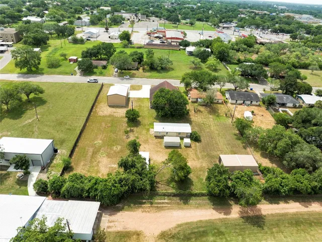 an aerial view of residential houses with outdoor space and swimming pool