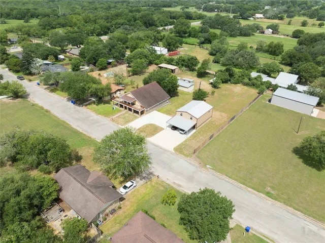 an aerial view of residential houses with outdoor space