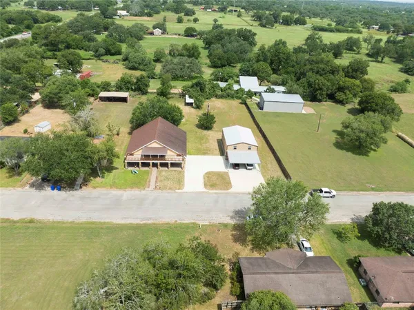 an aerial view of residential houses with outdoor space and swimming pool