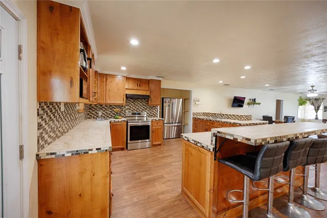 a large kitchen with a table and chairs in it