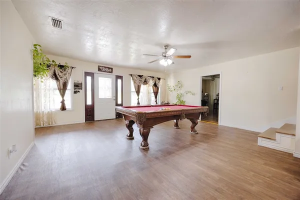 a room with furniture and pool table