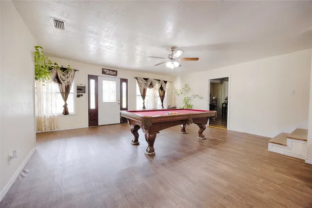 a room with furniture and pool table