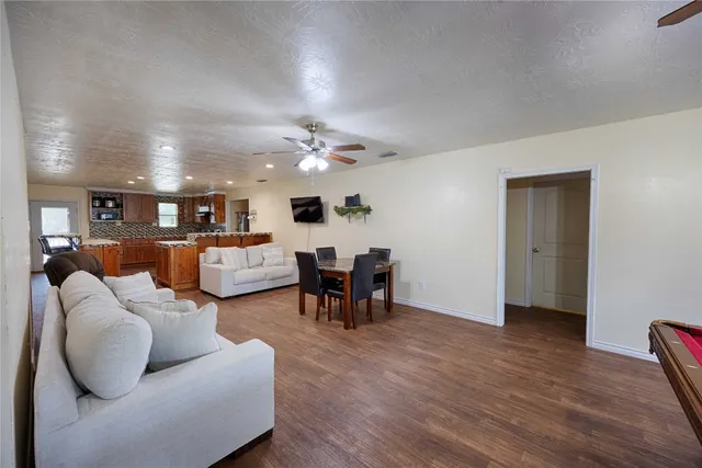 a living room with furniture and kitchen view