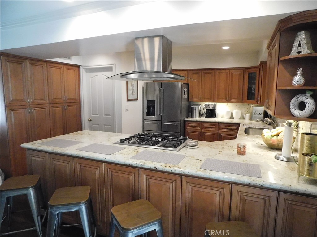 2013 Morning Canyon Road Diamond Bar, CA 91765 - Photo 3 of 26 a kitchen with a sink a stove and chairs