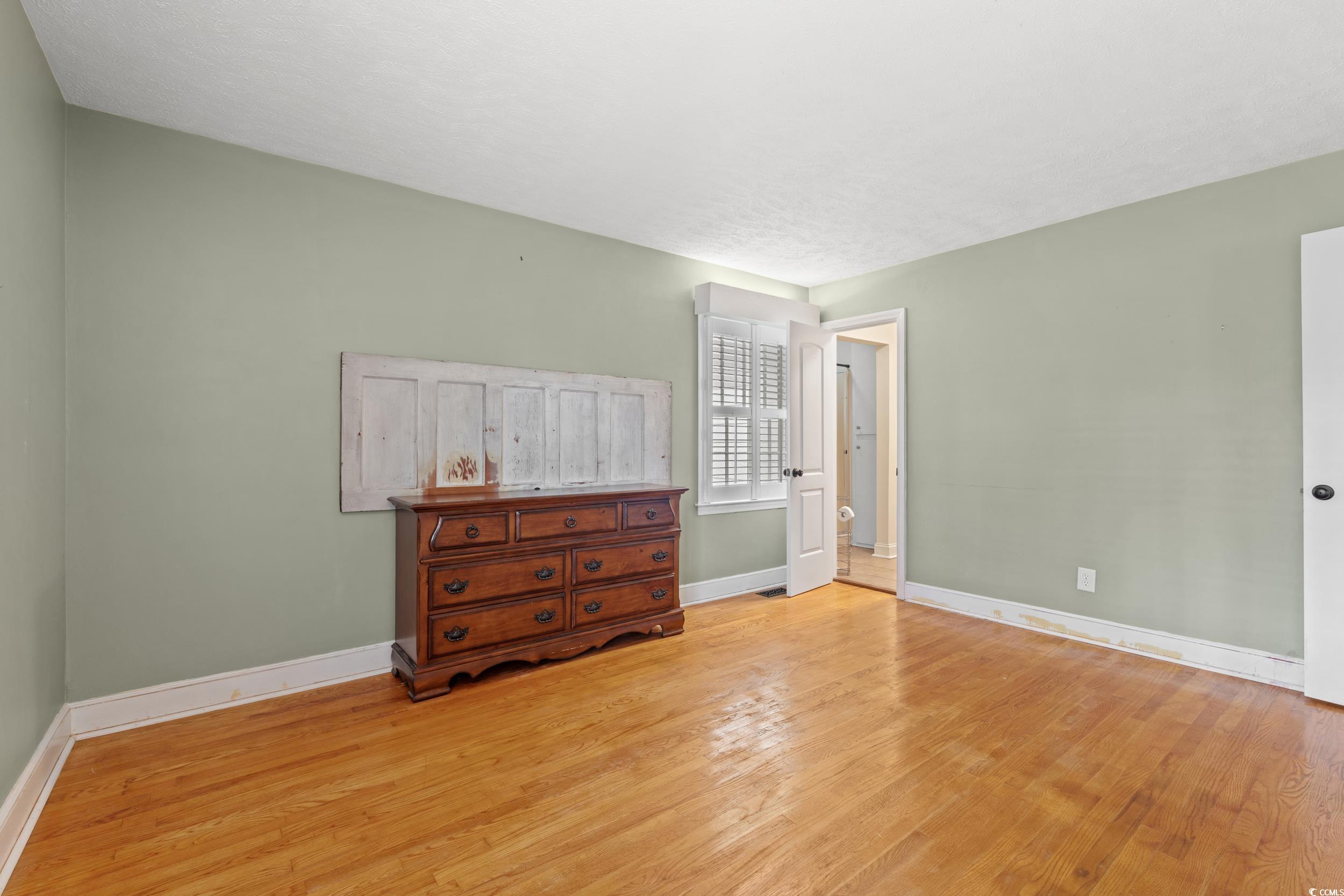 5033 State Rd S-34-470 Mullins, SC 29574 - Photo 8 of 32 Bedroom featuring light wood-type flooring and bas