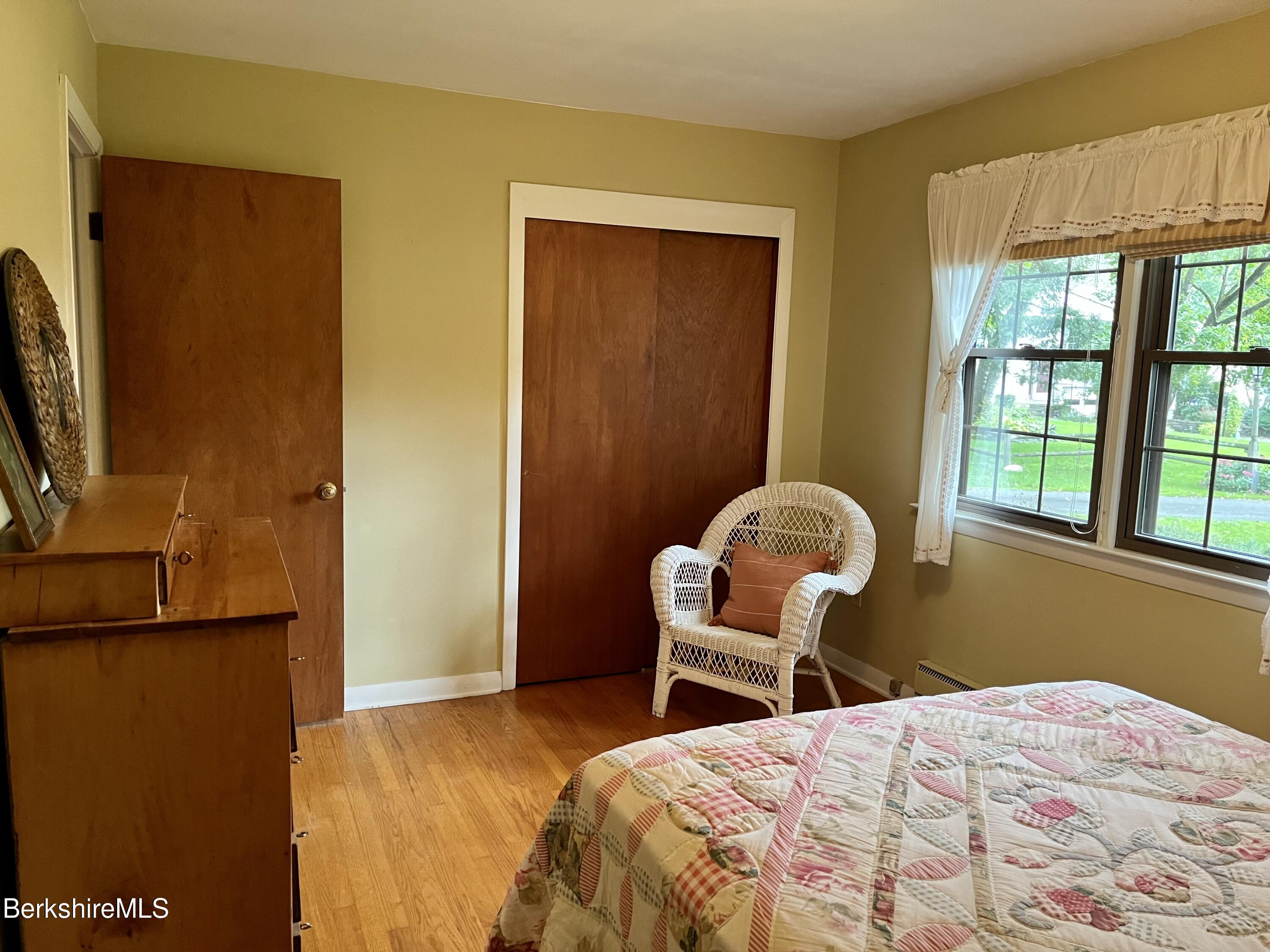 28 Chestnut Street Dalton, MA 01226 - Photo 18 of 33 a bedroom with a bed and a dresser next to a window