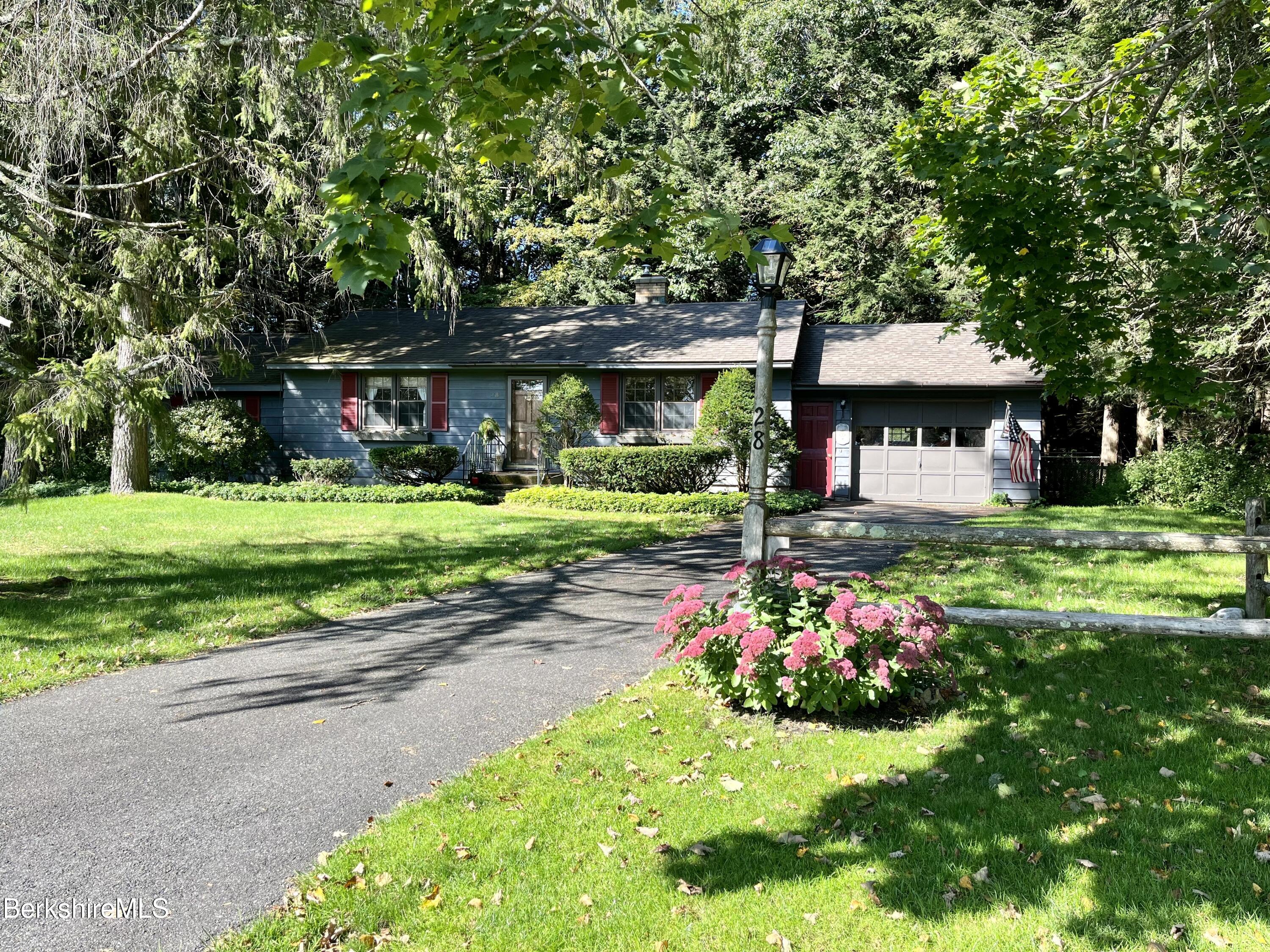 28 Chestnut Street Dalton, MA 01226 - Photo 2 of 33 a front view of a house with a yard table and chairs