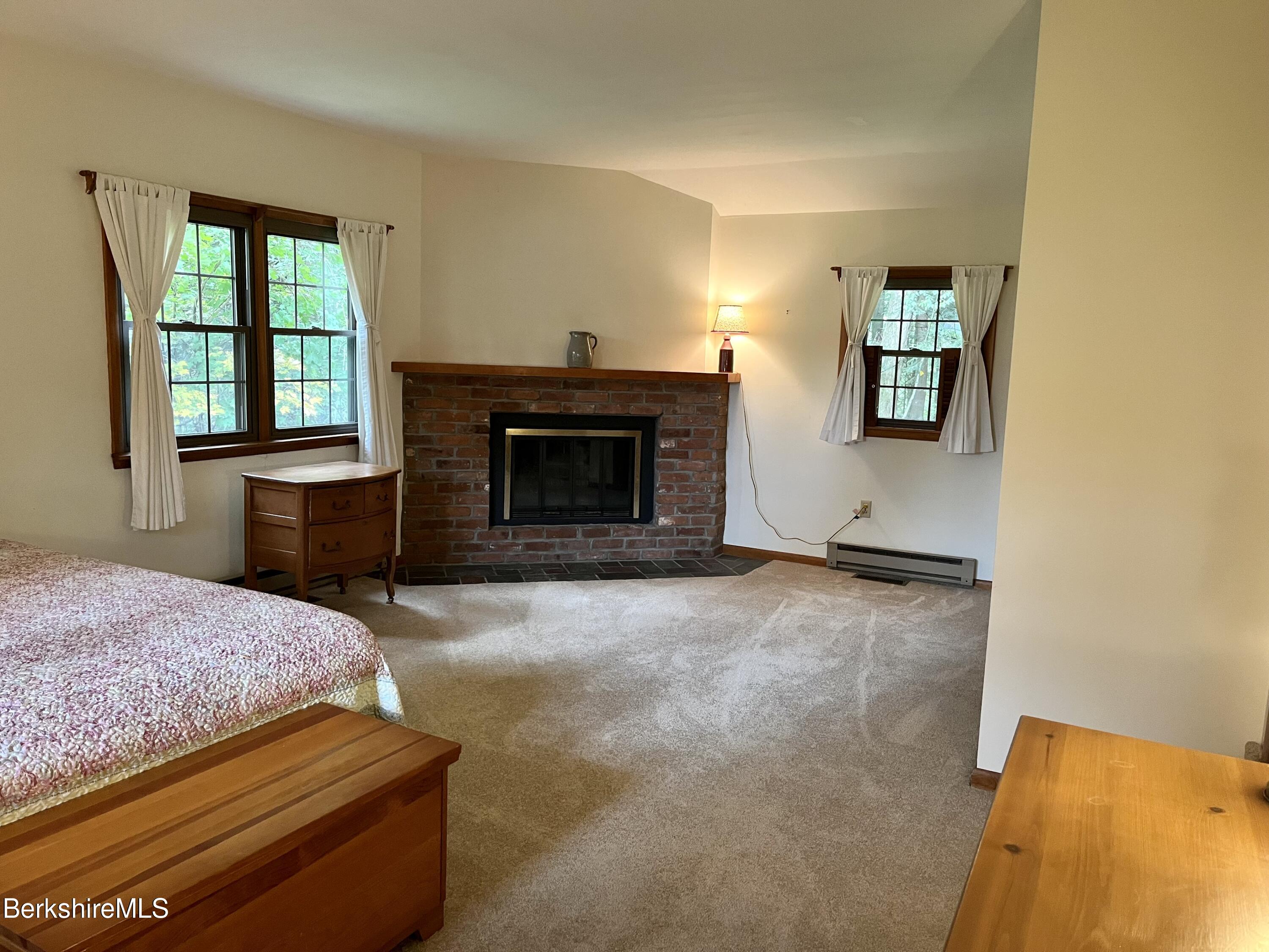 28 Chestnut Street Dalton, MA 01226 - Photo 22 of 33 a bedroom with a bed and a fireplace