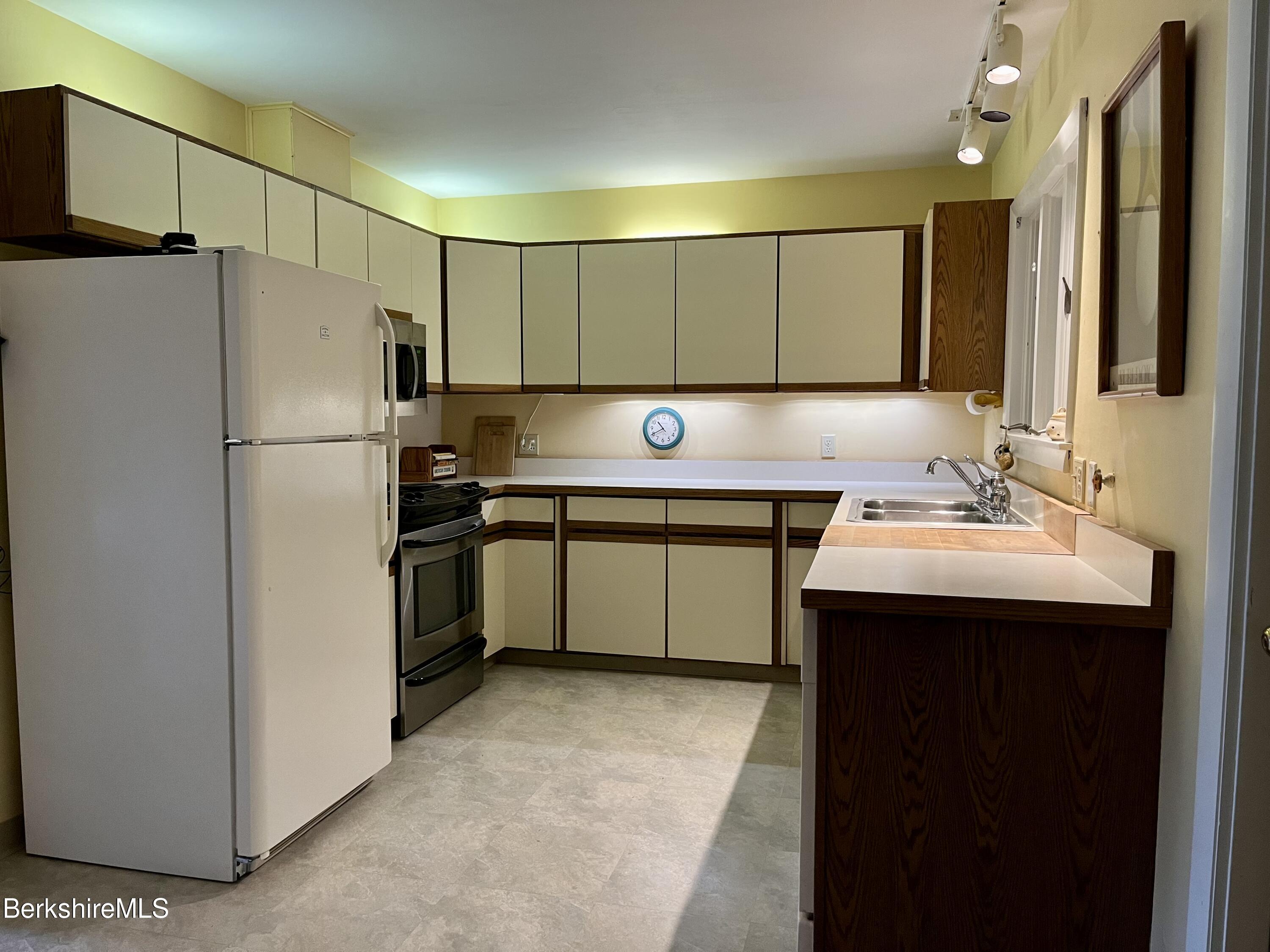 28 Chestnut Street Dalton, MA 01226 - Photo 8 of 33 a kitchen with a sink a refrigerator and a mirror