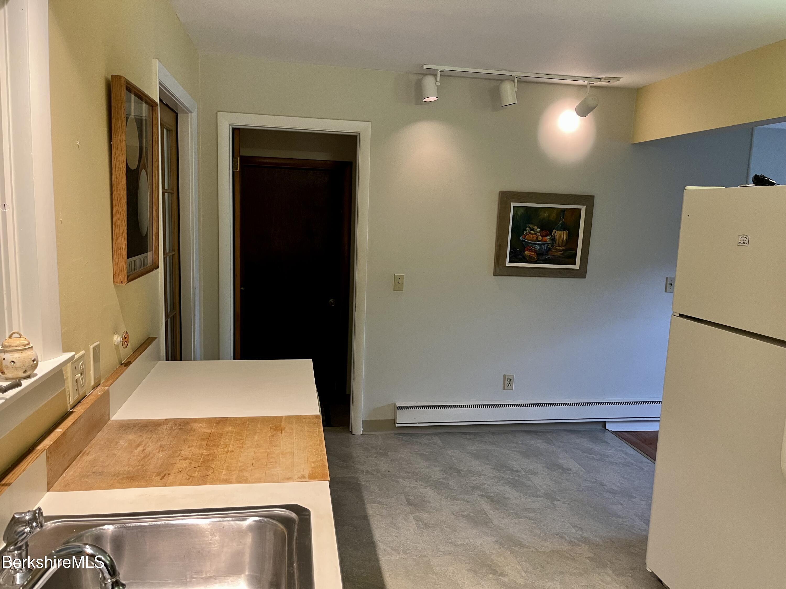 28 Chestnut Street Dalton, MA 01226 - Photo 10 of 33 a bedroom with a bed and a refrigerator