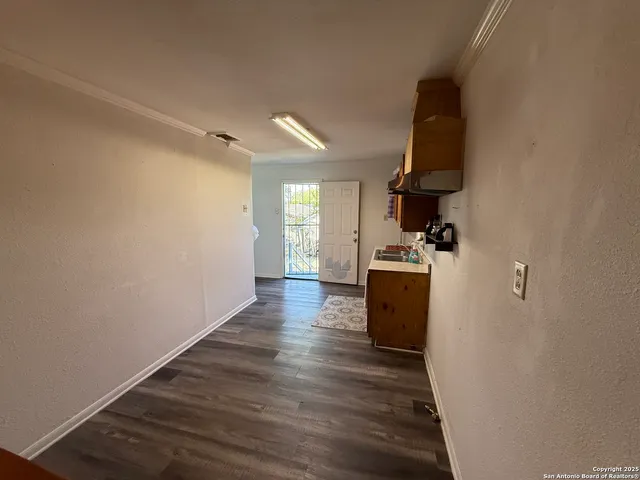 wooden floor in an empty room and a stove top oven