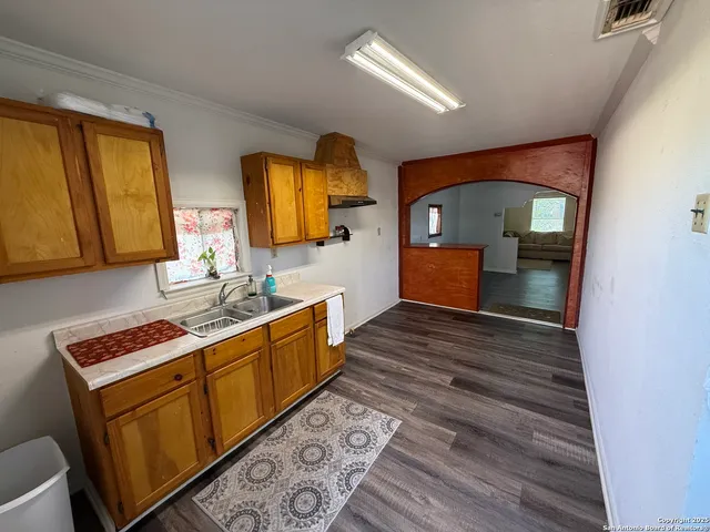 a room with wooden floor and furniture