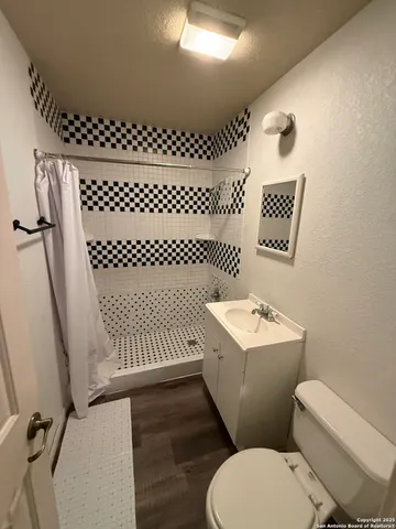 a bathroom with a sink toilet and mirror