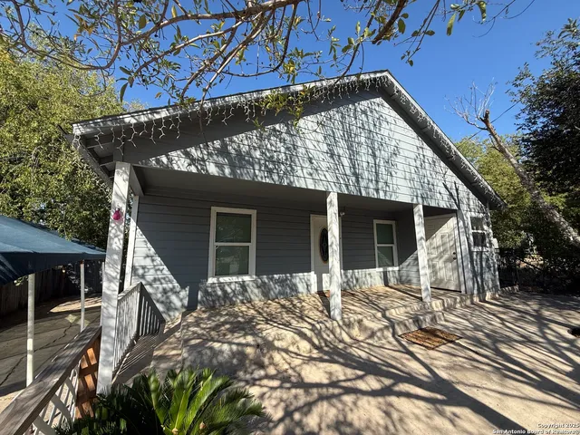 a front view of house with yard outdoor seating and pathway