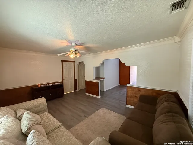 a living room with furniture and a chandelier