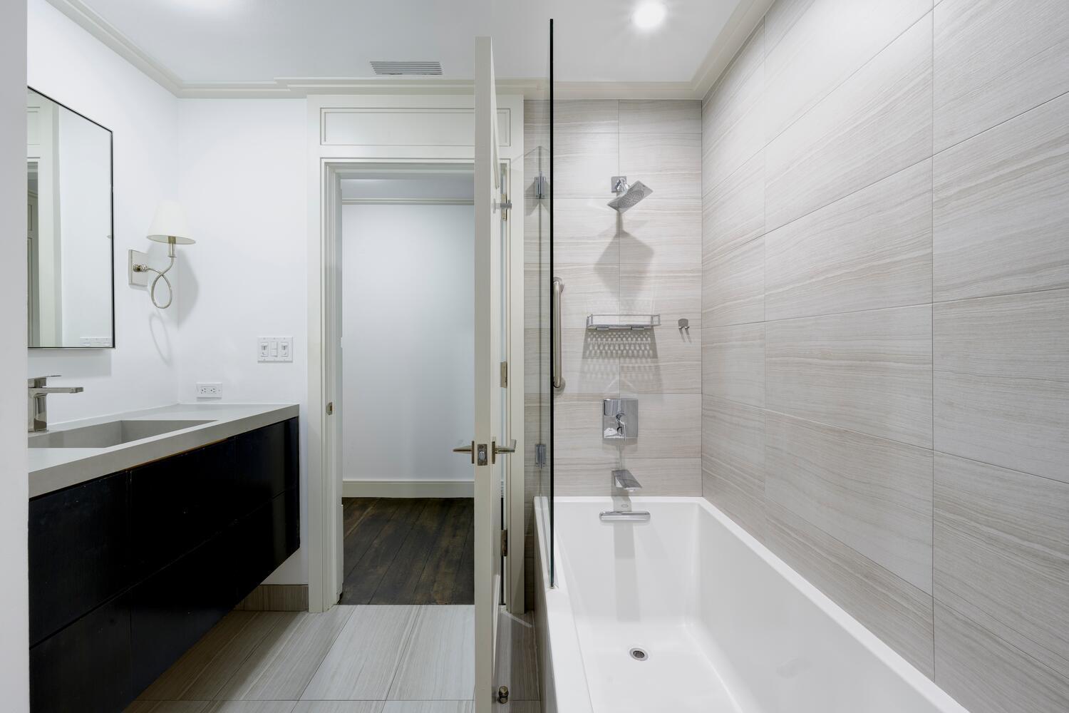 429 Australian Avenue, Unit 9 Palm Beach, FL 33480 - Photo 14 of 18 a bathroom with a bathtub and a sink