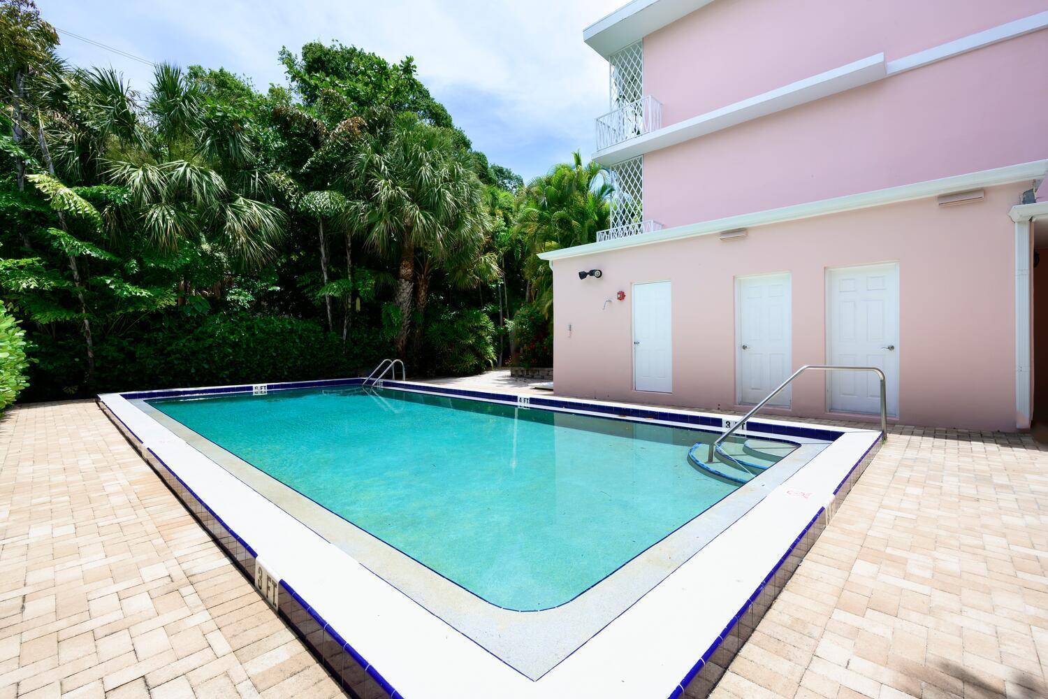 429 Australian Avenue, Unit 9 Palm Beach, FL 33480 - Photo 18 of 18 a view of a pool with a bench in the background