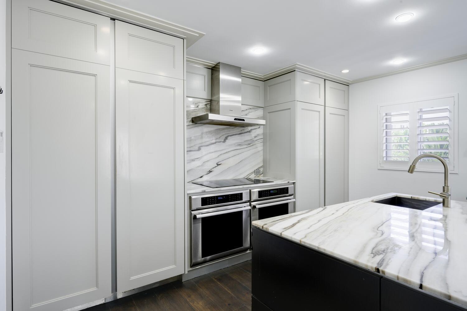 429 Australian Avenue, Unit 9 Palm Beach, FL 33480 - Photo 3 of 18 a kitchen with stainless steel appliances kitchen island a refrigerator sink and stove