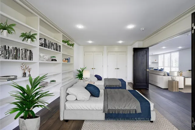 a living room with furniture flowerpot and wooden floor