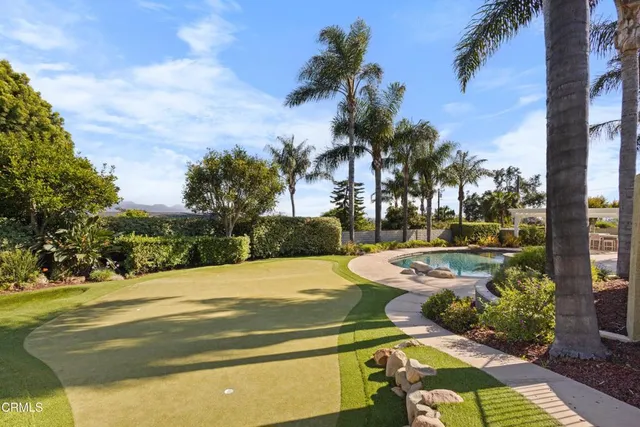 a view of a house with swimming pool and sitting area