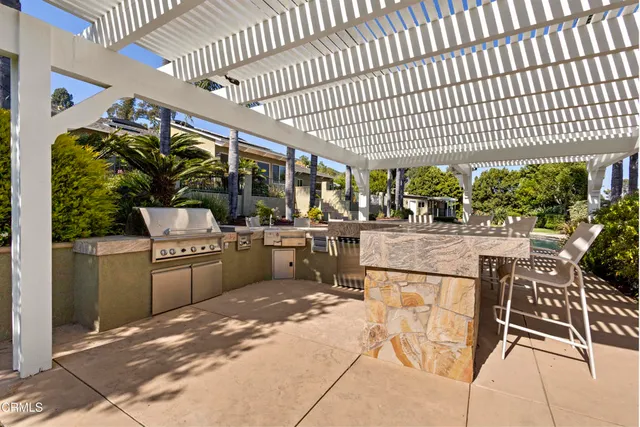a balcony with a potted plant on the roof