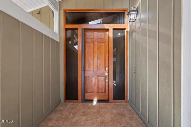 a hallway with dining table and chairs