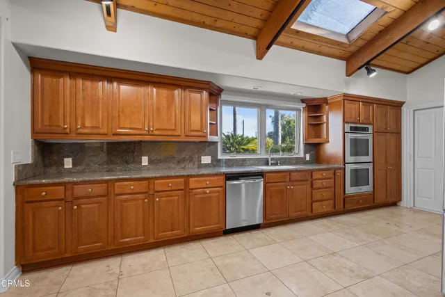 a large bathroom with a granite countertop sink a mirror and a shower