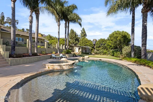 a view of a patio with table and chairs with wooden floor and fence