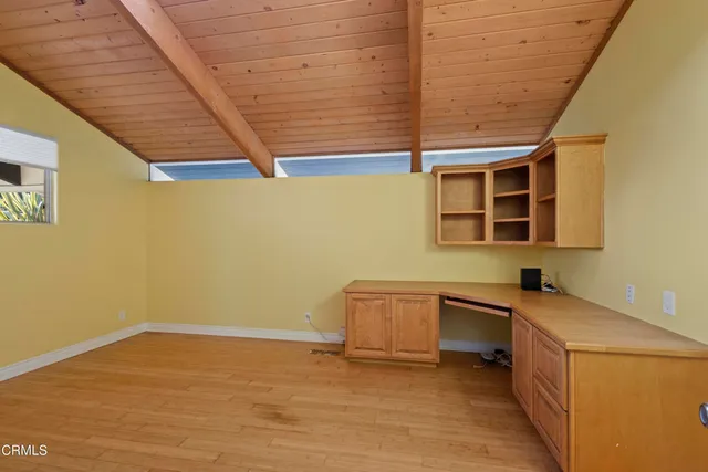 a large white kitchen with stainless steel appliances granite countertop a refrigerator and a stove top oven