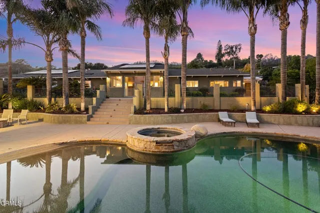 a swimming pool with outdoor seating and yard