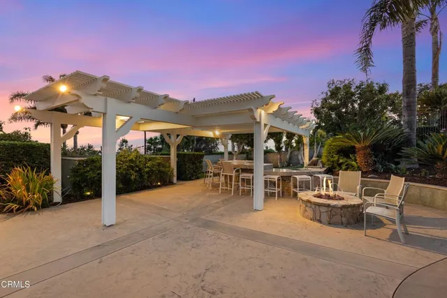 an aerial view of a house with a swimming pool and outdoor seating