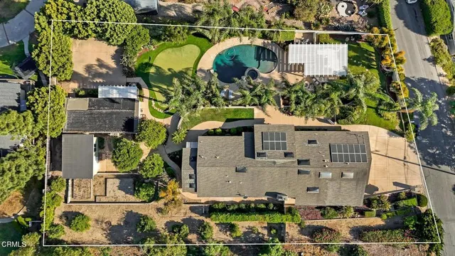 an aerial view of a house with a yard and lake view
